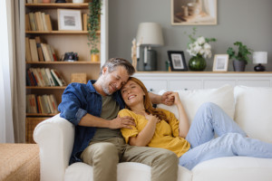 Couple relaxing on sofa, enjoying time together at home